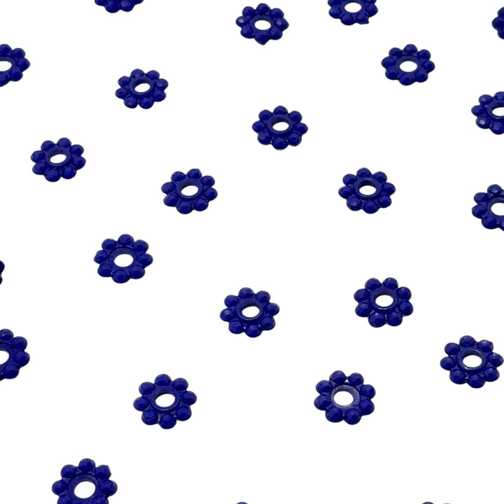 Pattern of blue flower-shaped objects on a white background