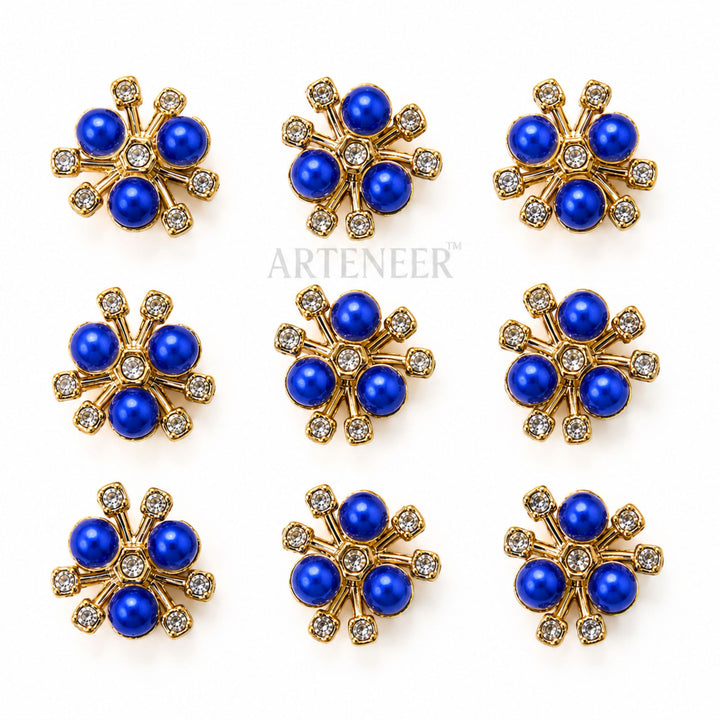 Set of blue flower-shaped earrings with gold and crystal accents on a white background, branded 'Arteneer'.