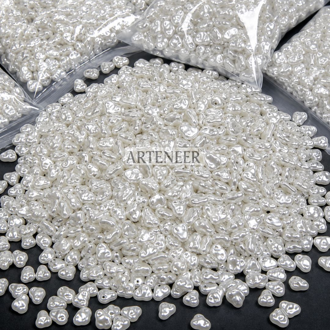 White pearl-like beads with 'Arteneer' branding on a black surface