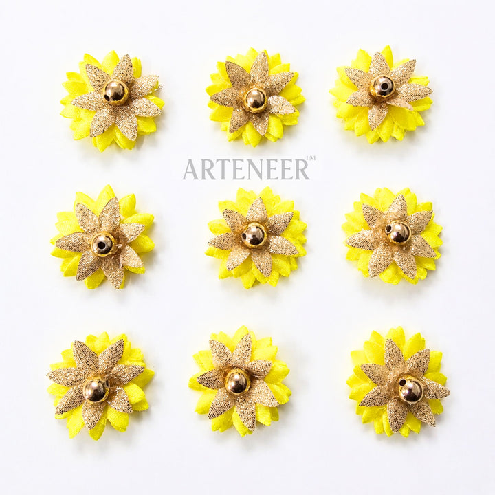 Yellow and gold flower-shaped earrings on a white background with 'Arteneer' branding.
